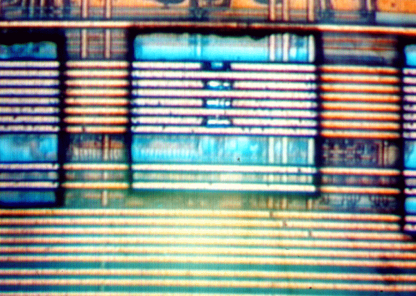 Photograph shows a 50 x 50 mm area of polyimide removed, SiO2 removed from 3 aluminum lines and the top aluminum line cut. This was performed using approximately 50 shots of low UV energy with a 50x near UV objective followed by four single shots of a 532 nm laser at approximately 40% power using a 100x objective, followed by a single shot of the 532 nm laser to cut the aluminum line. (Courtesy New Wave Research).