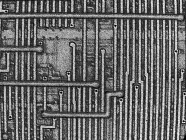 Photograph of a masking defect is shown at low magnification (200X). (Courtesy Sandia Labs)