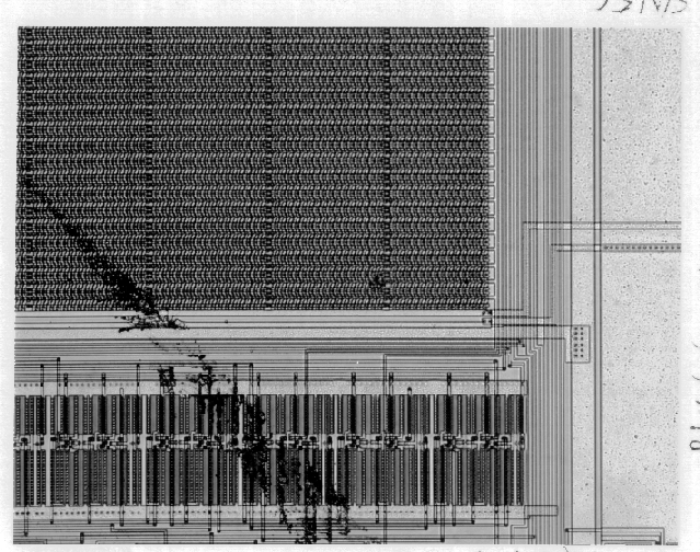 Photograph of mechanical damage is shown at low magnification (100X). (Courtesy Sandia Labs)