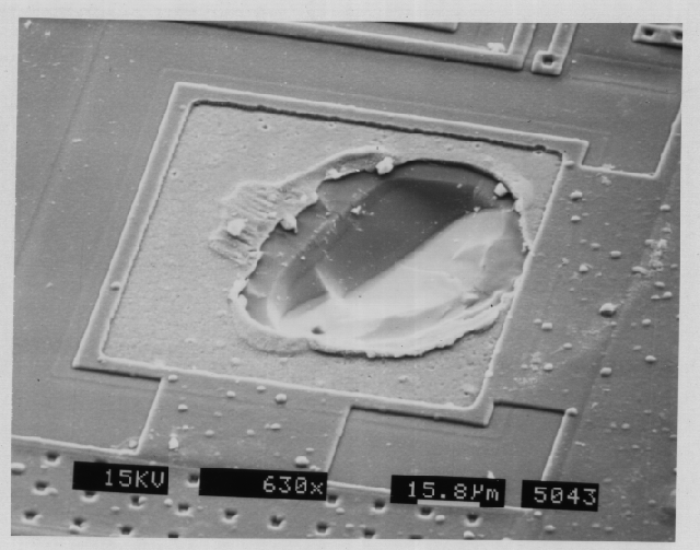 SEM image showing bond pad cratering. (Photo courtesy DM Data).