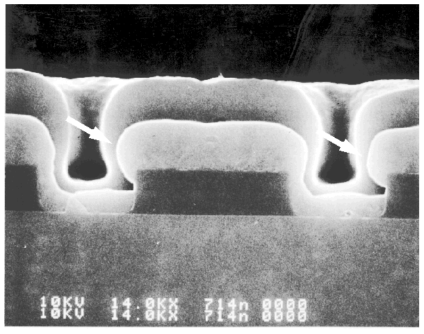 SEM image showing poor step coverage (breadloafing) of metal 1 into a silicon contact. (Courtesy Analytical Solutions).