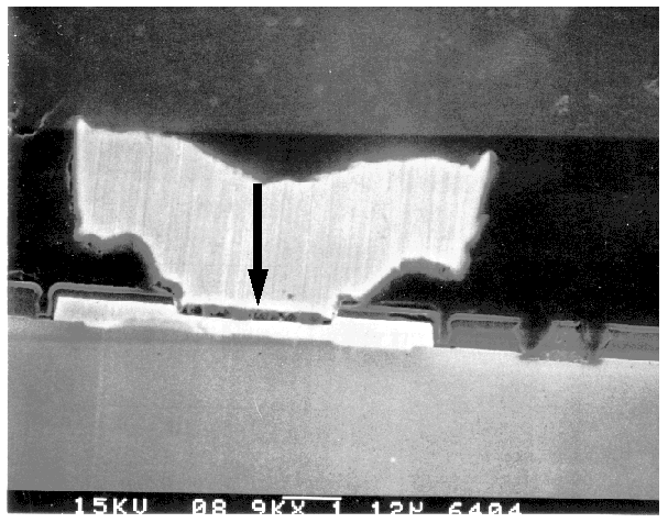 SEM image showing an open metal 1 - metal 2 contact. Oxide not fully removed from contact area. (Courtesy Analytical Solutions).