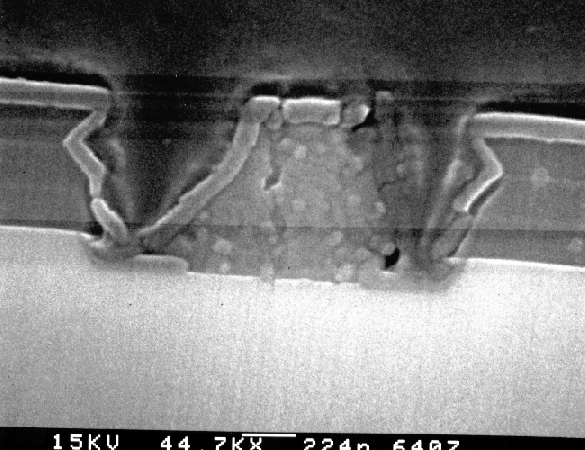 SEM image showing an overetched metal1 - Si contact and poor oxide coverage. (Courtesy Analytical Solutions).