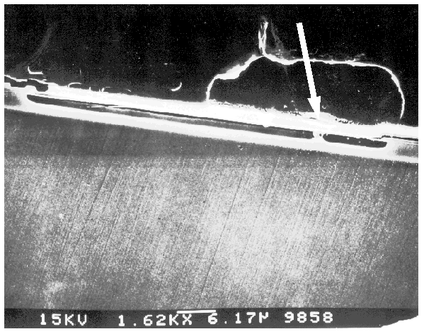 SEM image showing a metal to substrate short on a capacitor on a bipolar IC. (Courtesy Analytical Solutions).