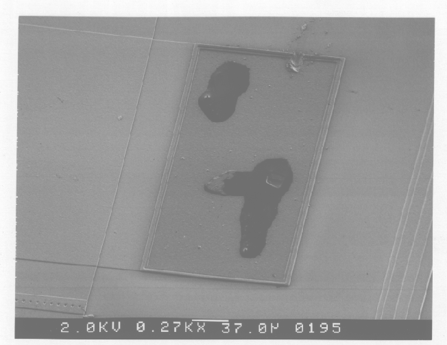SEM image showing contamination on a bond pad. (Photo courtesy DM Data.).