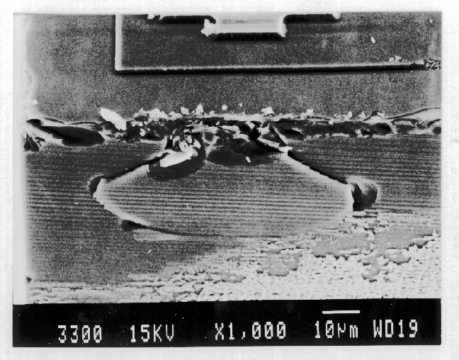 SEM image showing a cracked die. Crack propagates into the substrate. (Photo courtesy Analytical Solutions).