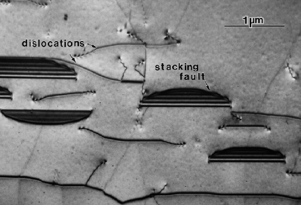 Plan-view image of oxidation-induced stacking faults and dislocations in a silicon substrate. (Courtesy Sandia National Laboratories).