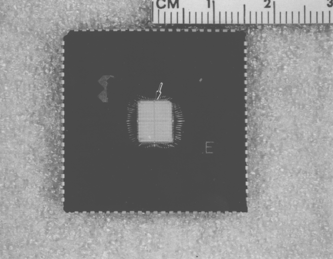 Shows a die which was decapsulated using the jet etch technique. Photo courtesy of Analytical Solutions, Inc.