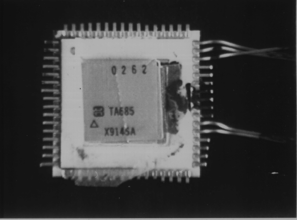 An example of contamination bridging two or more leads on an IC. (Photo courtesy Sandia Labs).