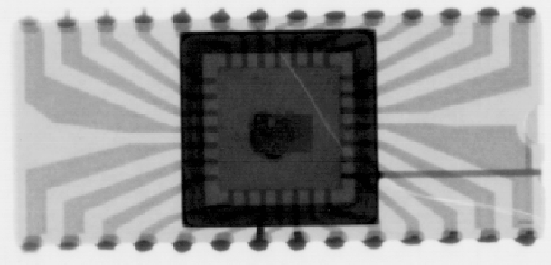 X-ray image showing a Dual In-line Package (DIP) which has a crack running through the ceramic body. This radiograph was produced on a positive acting Polaroid print medium. (Courtesy Sandia Labs).