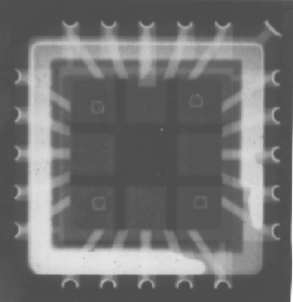 X-ray image showing a Leadless Chip Carrier (LCC) which had a ceramic lid sealed to it using gold-tin eutectic solder in a heated platen sealer. The defect in the lower left corner resulted from a raised corner on the lid which caused a breach in the solder seal. (Courtesy Sandia Labs).